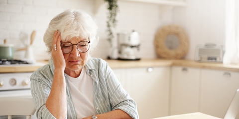 Elderly woman looking at finances