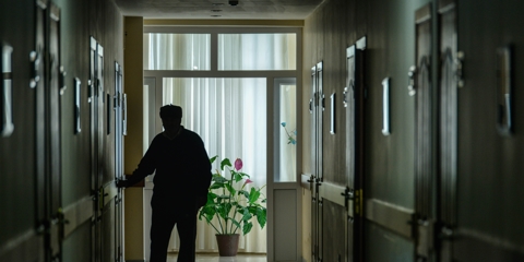 older man in a dark hallway of a nursing home