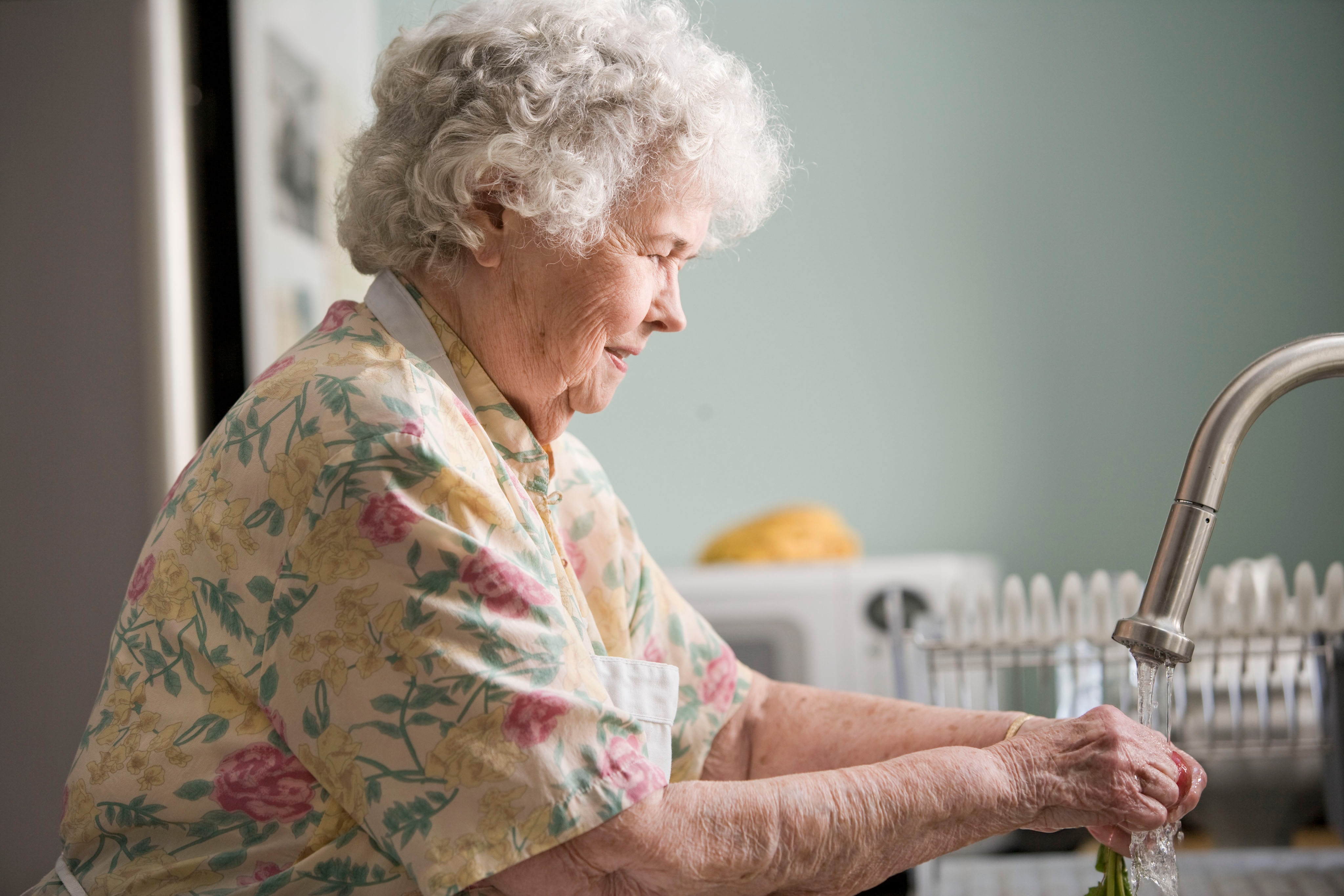 elderly woman washing hands
