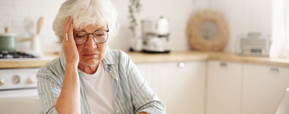 Elderly woman looking at finances