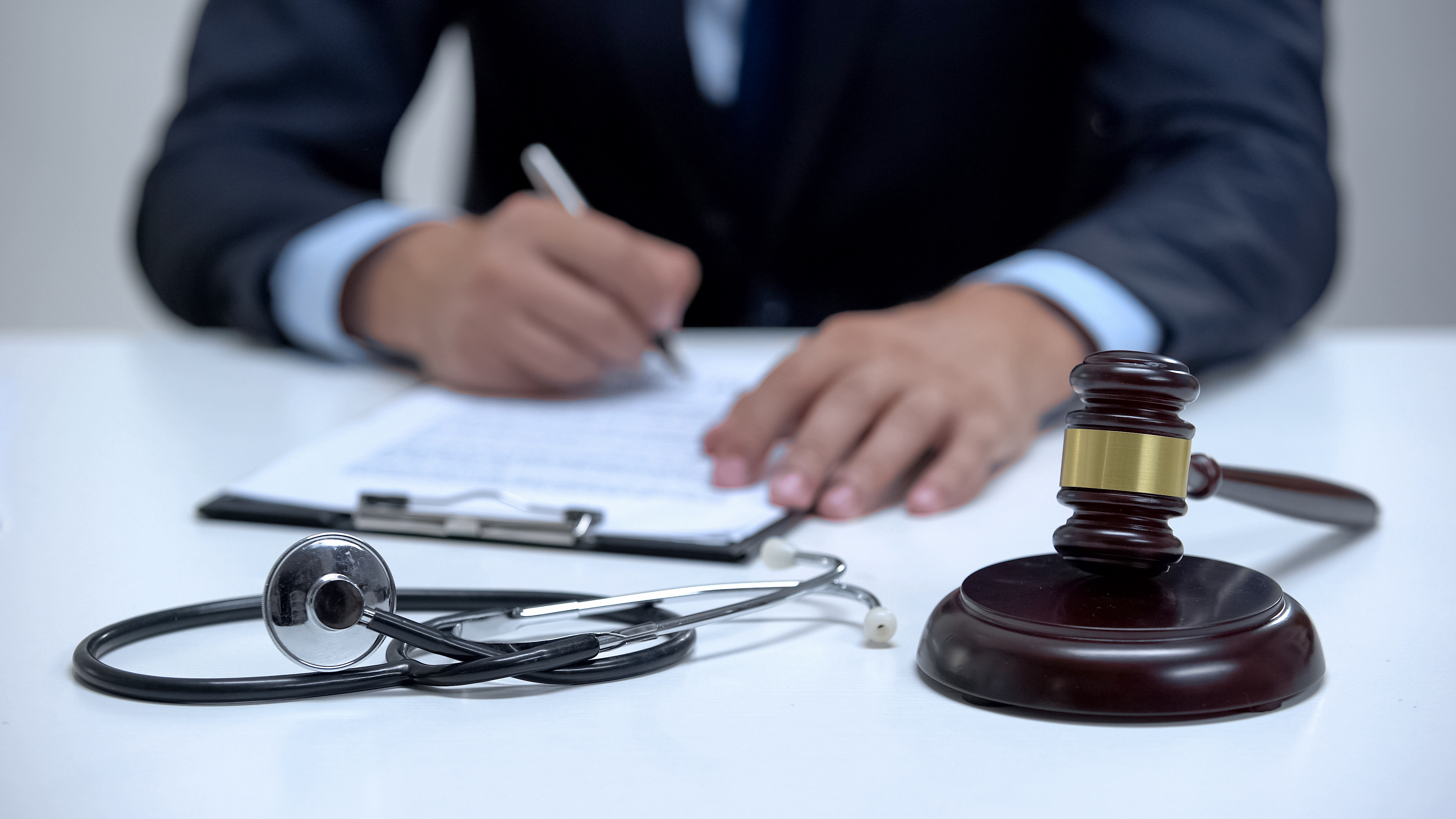 man in a suit with stethoscope and gavel